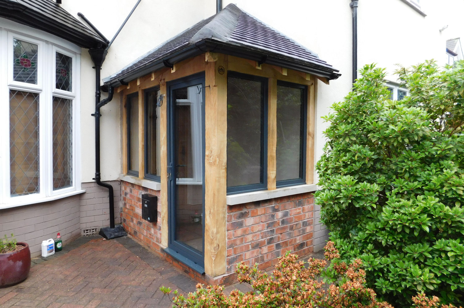 Enclosed Oak frame porch, dwarf wall, hipped roof ...