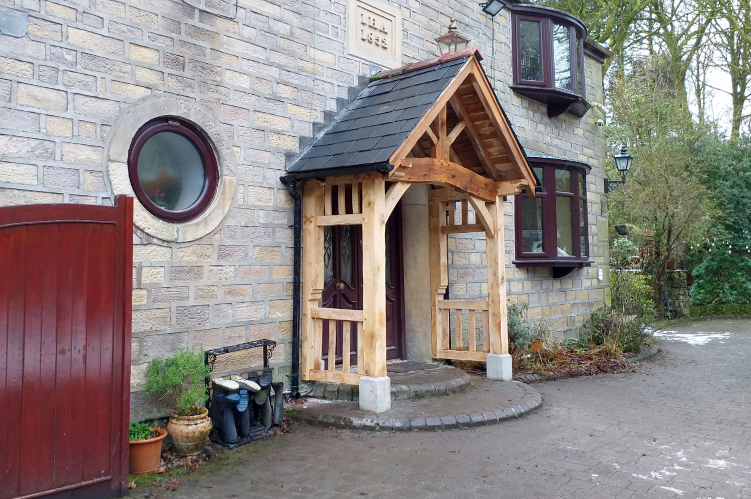 Porch, oak frame with naturally curved head beam, pitched, slated roof, Bolton, construction by Oak Carpentry Lancs